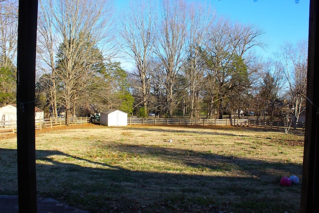 view of yard featuring a rural view and a storage unit