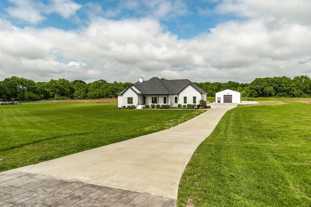 view of front of property featuring a front yard and a garage