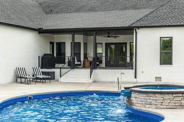 view of swimming pool featuring ceiling fan, french doors, an in ground hot tub, and a patio