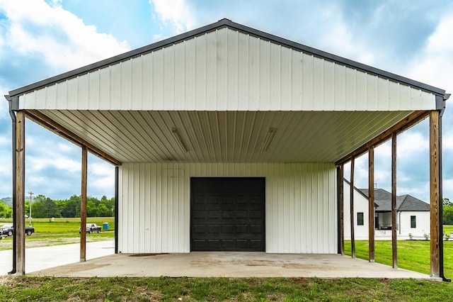 exterior space with a garage and a lawn