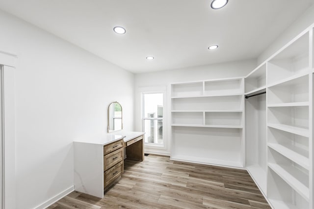 walk in closet featuring light hardwood / wood-style flooring