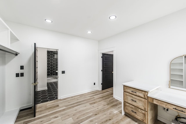 home office with light hardwood / wood-style flooring