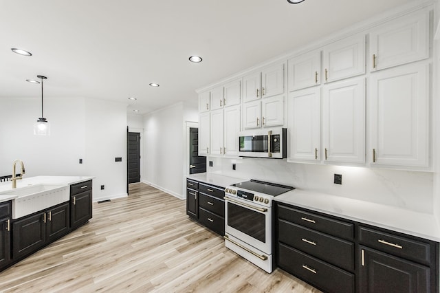 kitchen featuring white cabinets, pendant lighting, white electric range oven, and sink