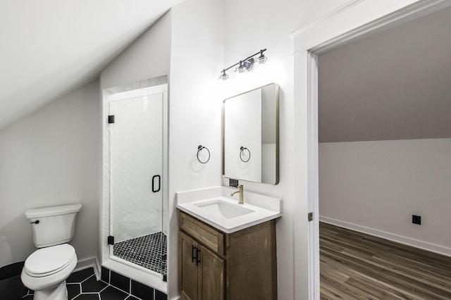 bathroom featuring a shower with door, vaulted ceiling, vanity, and toilet