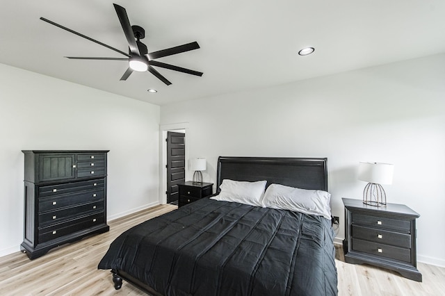 bedroom with ceiling fan and light hardwood / wood-style flooring