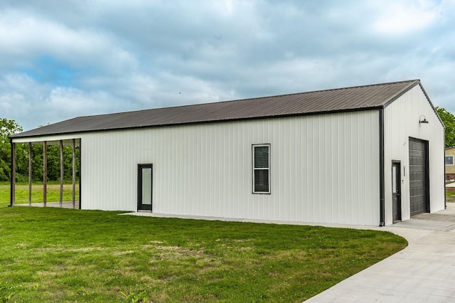 view of outdoor structure with a yard and a garage