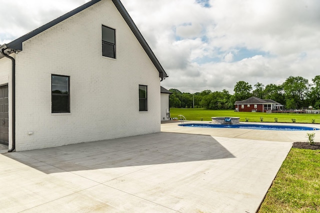 view of pool with a lawn and a patio area