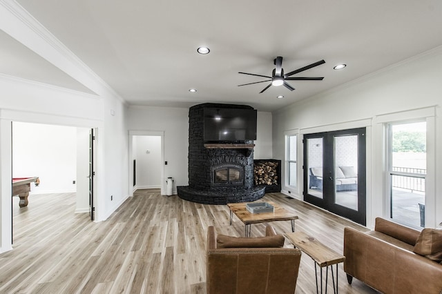 living room with a wood stove, pool table, ceiling fan, light hardwood / wood-style floors, and crown molding