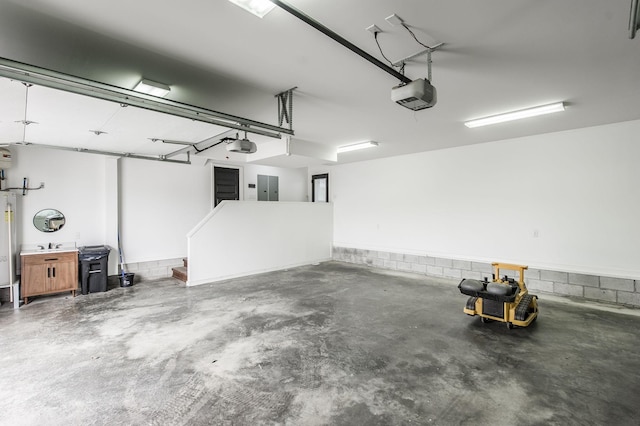 garage with electric panel, a garage door opener, and water heater