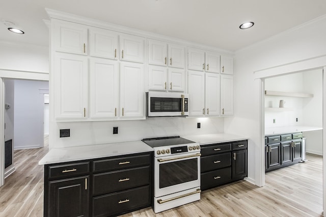 kitchen featuring white appliances, light wood-type flooring, white cabinets, and crown molding