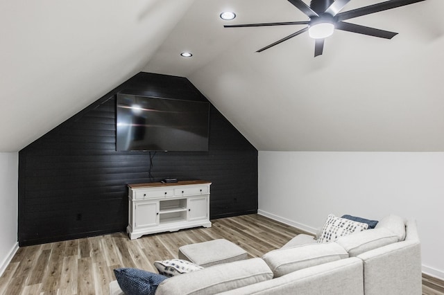 living room with lofted ceiling, ceiling fan, and light hardwood / wood-style floors