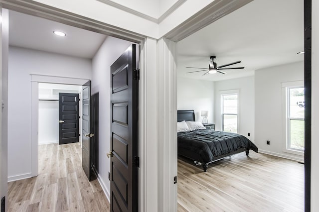 bedroom featuring ceiling fan and light hardwood / wood-style flooring