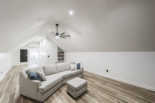 living room featuring lofted ceiling, ceiling fan, a wall mounted air conditioner, and light hardwood / wood-style flooring