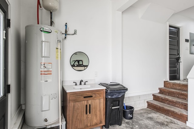 bathroom with concrete flooring, electric water heater, and vanity