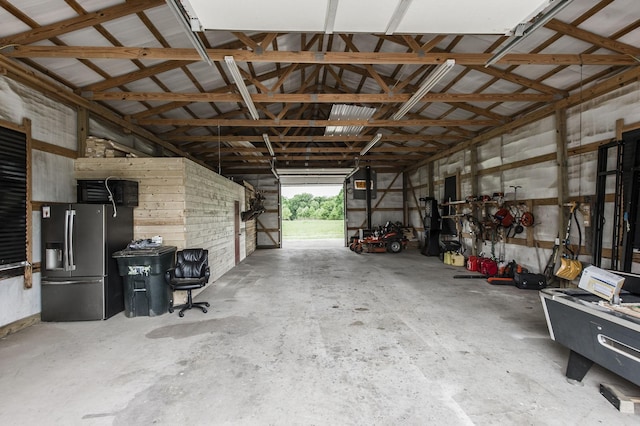 garage with stainless steel refrigerator with ice dispenser