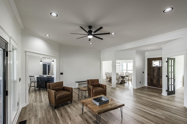 living room with french doors, ceiling fan, crown molding, and wood-type flooring