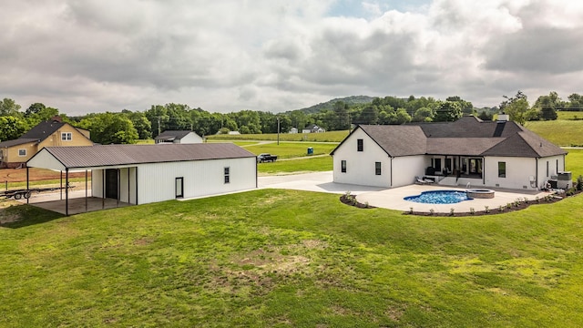 rear view of house with a lawn and a patio area