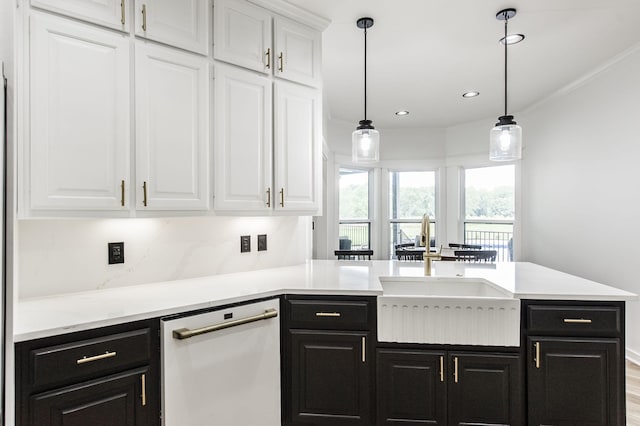 kitchen featuring sink, white cabinets, dishwasher, light wood-type flooring, and hanging light fixtures