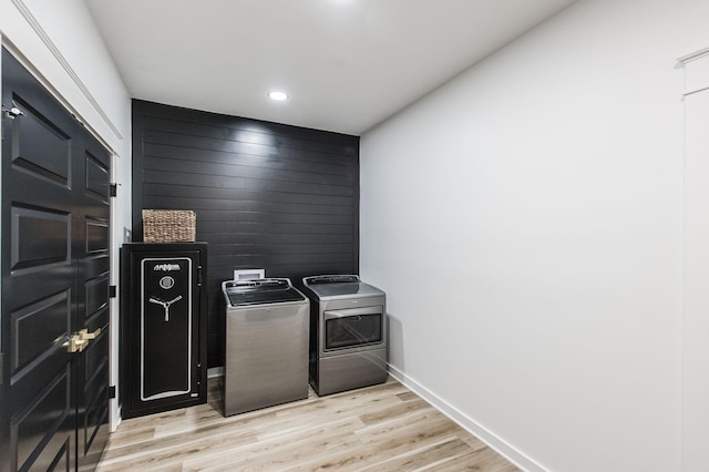 laundry room featuring light hardwood / wood-style floors and washing machine and clothes dryer