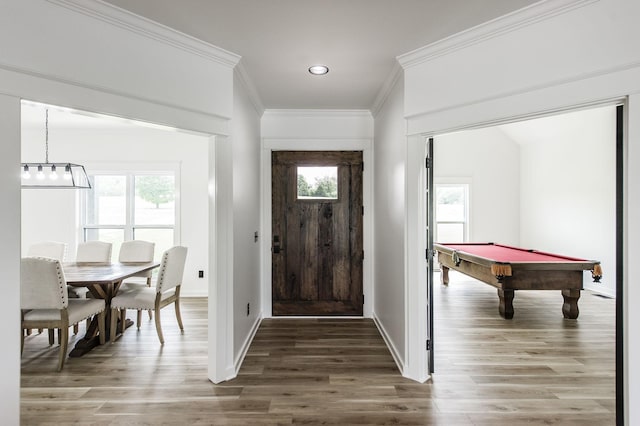 entryway with billiards, hardwood / wood-style floors, and crown molding