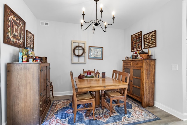 dining space featuring a notable chandelier and dark hardwood / wood-style flooring