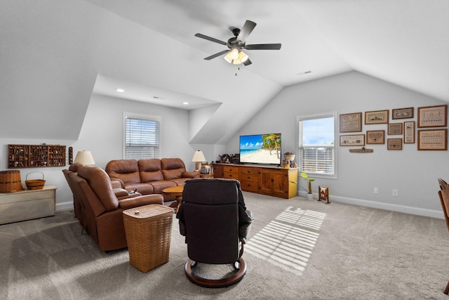 carpeted living room featuring ceiling fan and vaulted ceiling