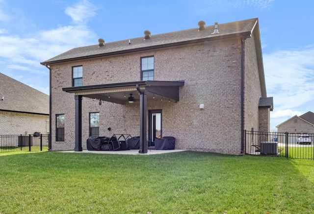 back of house with a patio, central air condition unit, ceiling fan, and a lawn