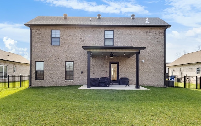 back of house with a patio area, ceiling fan, and a yard