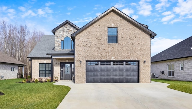 view of front of home with cooling unit, a front lawn, and a garage