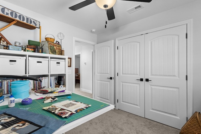 game room with ceiling fan and light carpet