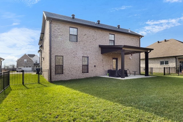 rear view of property with a yard and a patio