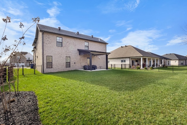 rear view of property featuring a yard and a patio