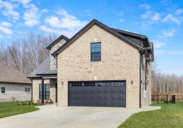 view of front of home featuring a garage and a front lawn