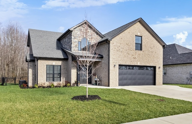 view of front of property with a garage, central air condition unit, and a front lawn