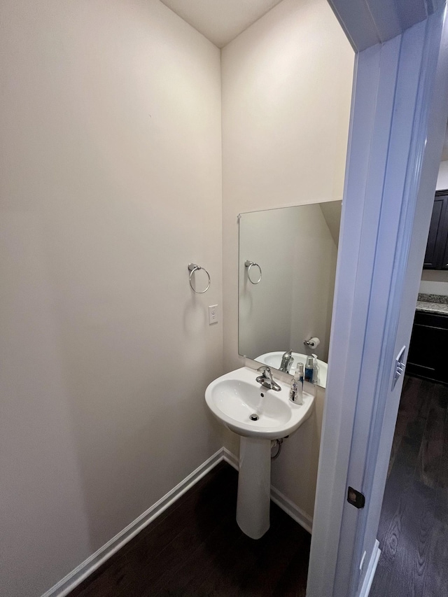 bathroom with hardwood / wood-style floors and sink