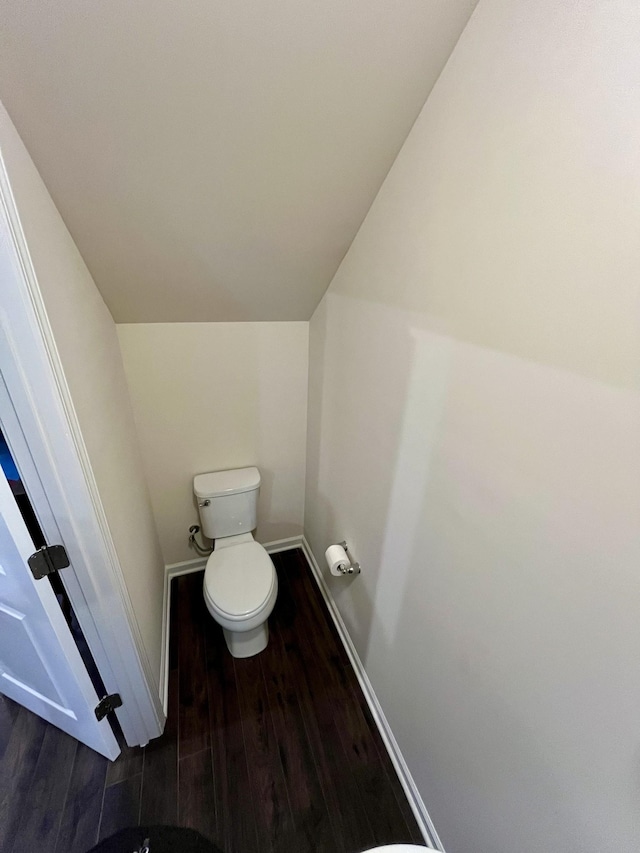 bathroom featuring wood-type flooring and toilet