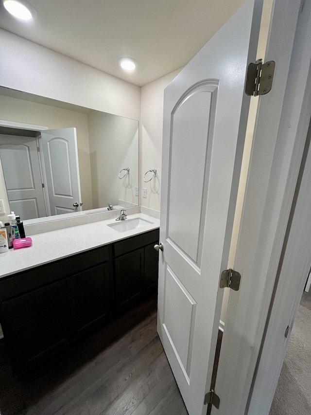 bathroom featuring vanity and hardwood / wood-style flooring