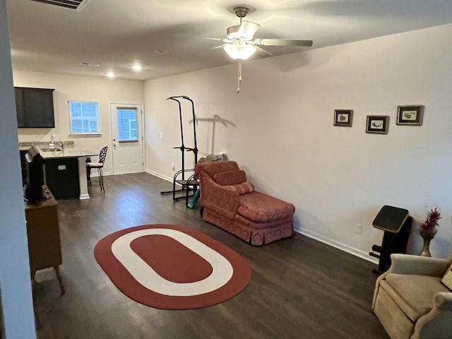 interior space with ceiling fan and dark hardwood / wood-style flooring