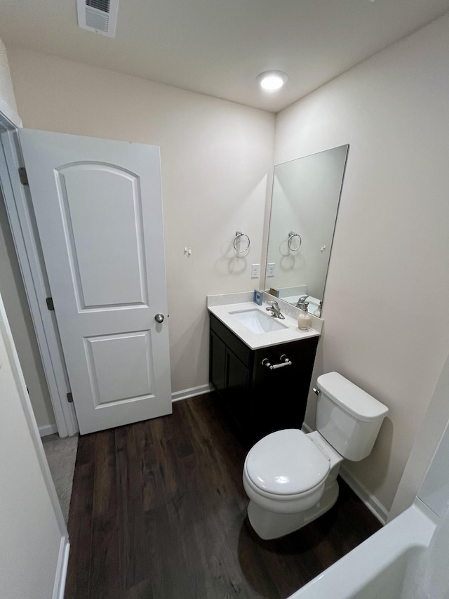 bathroom featuring hardwood / wood-style floors, vanity, and toilet