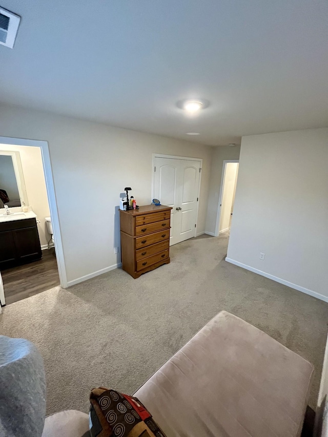 interior space with light carpet and ensuite bath