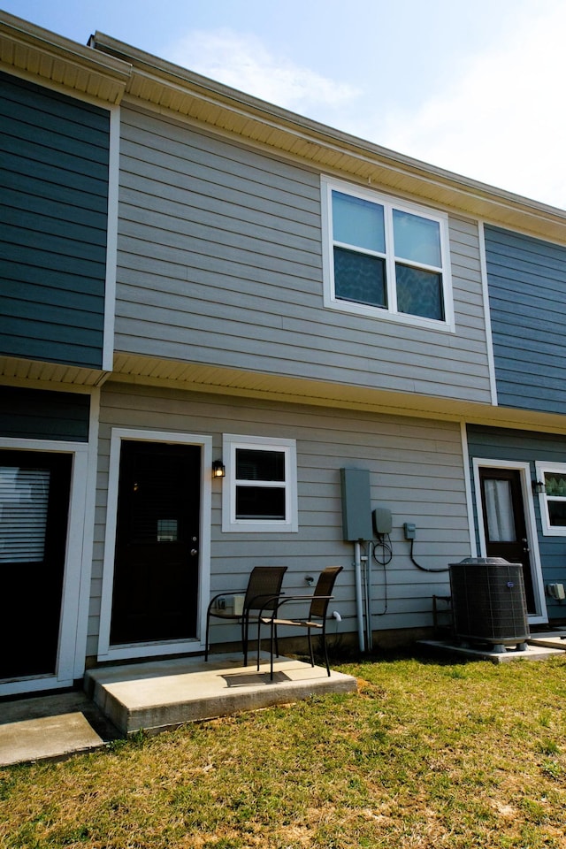 back of house with a yard, a patio, and central AC