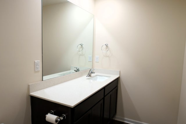 bathroom featuring baseboards and vanity