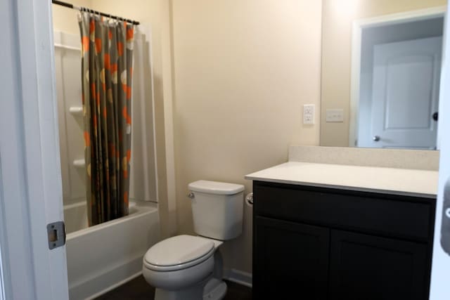 bathroom with vanity, toilet, and shower / bath combo with shower curtain