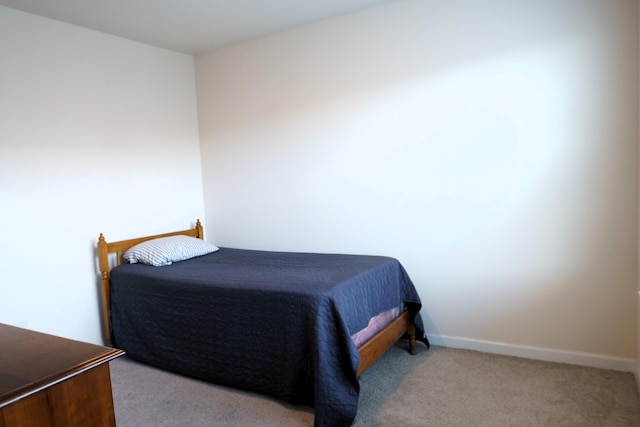 carpeted bedroom featuring baseboards