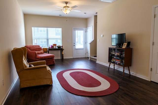 living room with visible vents, baseboards, ceiling fan, and wood finished floors