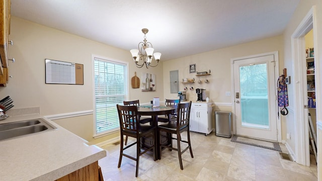 dining room with electric panel, sink, and an inviting chandelier