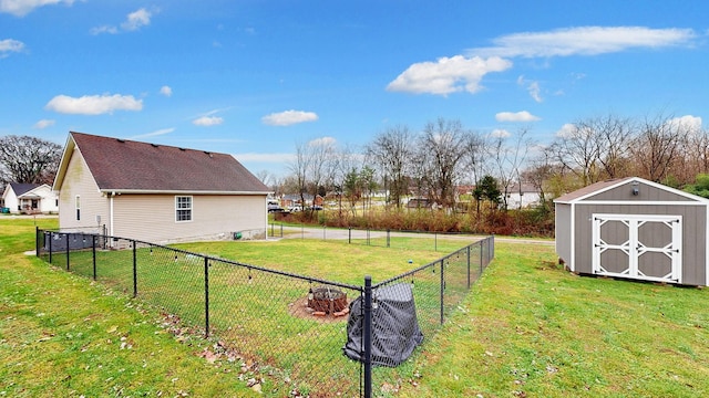 view of yard with a fire pit and a storage shed