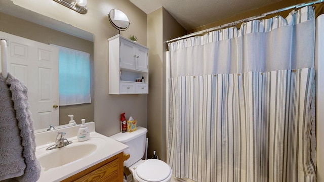 bathroom with curtained shower, vanity, and toilet