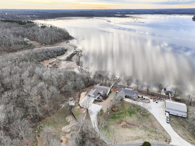 aerial view at dusk featuring a water view