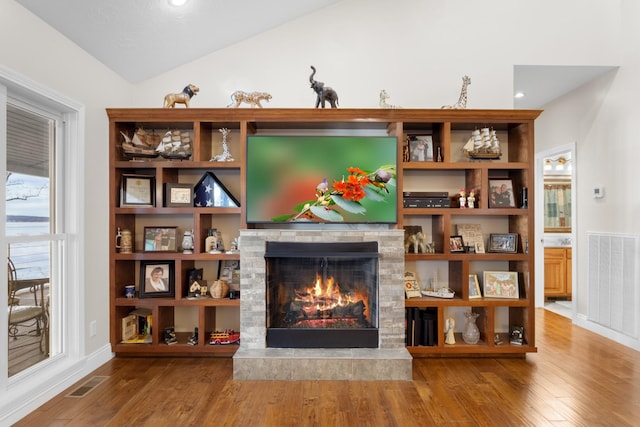 sitting room with wood-type flooring and lofted ceiling